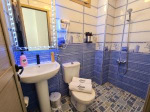 a blue tiled bathroom with a toilet and a sink at White Majorelle Azul in Tamraght Ouzdar +92 photos