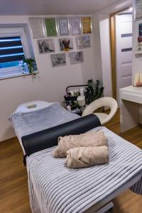 a hospital bed with towels on it in a room at Trzy Wzgórza Huwniki in Huwniki +8 photos