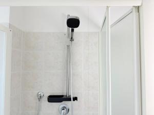 a shower with a shower head in a bathroom at C019 - Camerano, ampio trilocale con WiFi in Camerano +8 photos