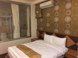 Postel nebo postele na pokoji v ubytování Ri Yue Hu Pan Resort