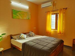 a bedroom with a bed and a window at Hamsa Farmstay - 2BHK AC Homestay in Mysore