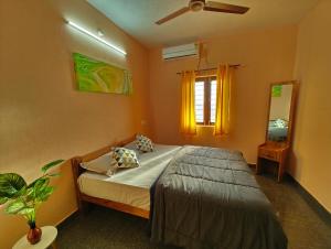 a bedroom with a bed and a window at Hamsa Farmstay - 2BHK AC Homestay in Mysore