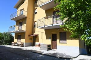 a yellow building with balconies on a street at C019 - Camerano, ampio trilocale con WiFi in Camerano