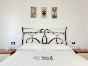 a bedroom with a white bed with a black headboard at C019 - Camerano, ampio trilocale con WiFi in Camerano