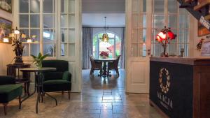a room with a table and chairs and a room with a door at Dworek Akacja in Janowiec
