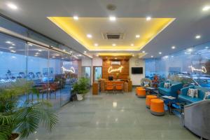 a lobby with blue couches and chairs in a building at Zone Connect by The Park Katra in Katra