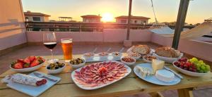 a table full of food and wine on a balcony at Villa Colibri Dorado in Lajares