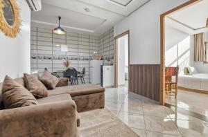 a living room with a couch and a kitchen at White Majorelle Horizon in Tamraght Ouzdar