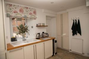 a kitchen with a sink and a window at Snow Cottage, Old Aberdeen, 3 bedroom luxury in Aberdeen +26 photos