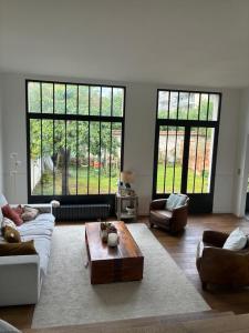 a living room with a couch and a coffee table at Grande maison familiale rénovée en 2025 in Versailles
