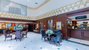 a dining room with a table and chairs at Habitat All Suites, Al Khobar in Al Khobar