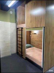 a room with a bunk bed in a room at Kochevnik capsule Hostel in Almaty