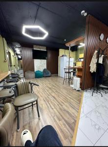 a room with a couch and chairs in it at Kochevnik capsule Hostel in Almaty