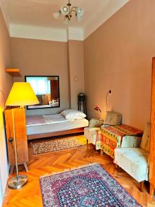 a living room with a bed and a couch at Retró Kúria in Fonyód
