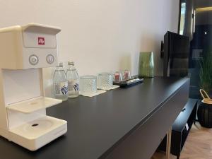 an office counter with a drink machine on it at XIX Boutique Apartment in Skopje