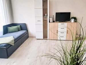 a living room with a couch and a tv at Metro Budějovická apartment in Prague