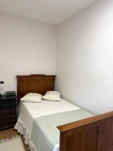 a bedroom with a bed with two pillows on it at Casa da Linha in Caminha