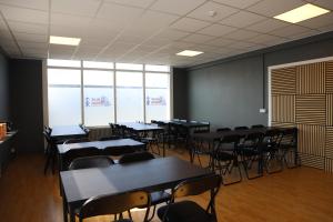a classroom with tables and chairs in a room at Blue Viking Pods in Keflavík