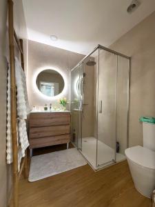 a bathroom with a shower and a sink and a toilet at Casa da Linha in Caminha +17 photos