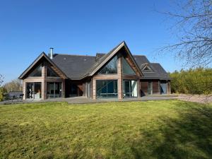 a house with a gambrel roof at Harizou - Chalet & Piscine Intérieure in Saint-Pierre-la-Vieille
