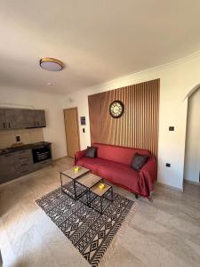 a living room with a red couch and a table at Nature Nest in Samos +9 photos