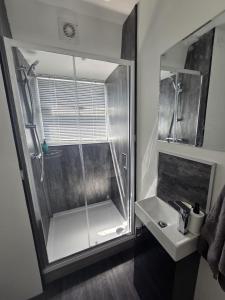 a bathroom with a shower and a sink at Fulham Guest Studios 268 in London +58 photos