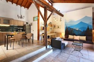 a kitchen and living room with a table and chairs at Blue Cottage in Apsiou