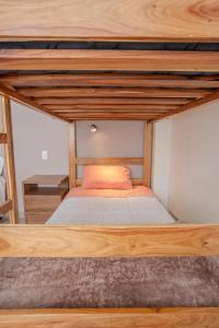 a bed in a room with a wooden bed frame at Me Gusta Sucre Inn in Sucre +17 photos