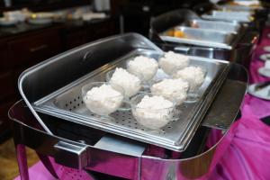 a row of trays filled with cupcakes on a table at Hotel Windsor Barranquilla in Barranquilla