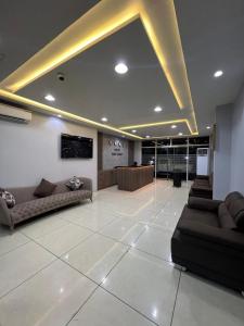 a large lobby with couches and a reception desk at Hotel Golf Coast in Kinshasa