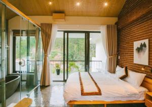 a bedroom with a bed and a large window at Shanti Wellness Sanctuary Đà Lạt in Da Lat +115 photos