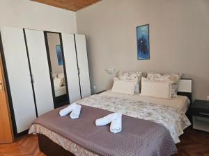 a bedroom with a bed with towels on it at Apartment Tičić in Povljana