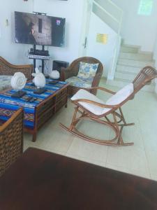 a living room with a chair and a table at Casa suites golden in Tonsupa