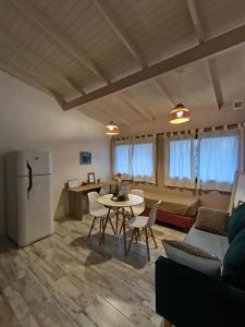 a kitchen and living room with a table and a refrigerator at 1991HospedajeD3 in Ensenada