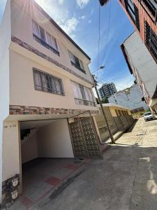 a building with a garage with a garage door open at ApartahotelVacacionalSangil in San Gil