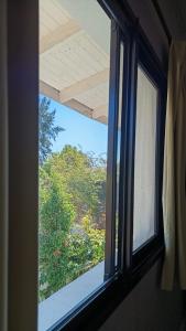 a window in a room with a view of a garden at 1991HospedajeD3 in Ensenada