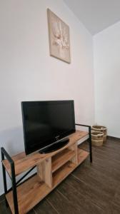 a flat screen tv sitting on top of a wooden table at Apartments Vista Muo 2026 NEWLY RENOVATED in Kotor