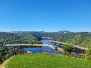a view of a river with a bridge in the distance at Le Panoramic Garabit in Anglards-de-Saint-Flour +21 photos