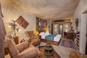 a bedroom with a bed and a couch at Cappa Via Cave Hotel in Ürgüp +168 photos