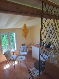 a living room with a table and some chairs at Casa Doudou in Bédoin