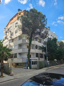 a building with a tree in front of it at SunBeach Apartament in Golem