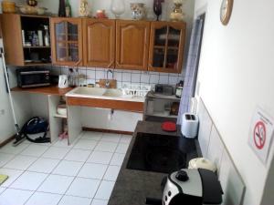 a small kitchen with a sink and a stove at Brise Fraîche de la Montagne-Piscine et Jacuzzi-Appartement Cottage au rez-de-chaussée in Le Poujol-sur-Orb
