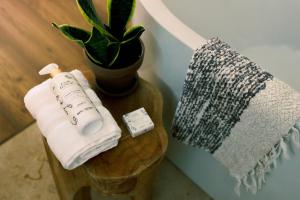 a bathroom with a roll of toilet paper and a plant at UMA Rural Boutique - La Garrotxa in Mieras +48 photos