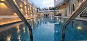 a swimming pool in the middle of a building at Hotel Golf Coast in Kinshasa