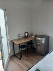 a small kitchen with a table and a refrigerator at White House in Gyumri +15 photos