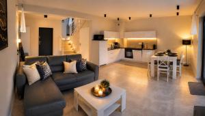 a living room with a couch and a table and a kitchen at Villa LUX Luis in Dziwnów