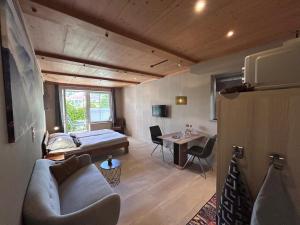 a room with a couch and a bed and a table at FeWo Marielle in Seeboden