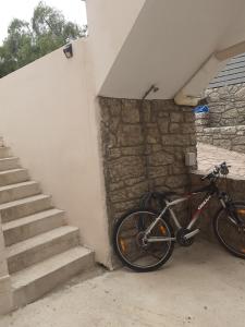 a bike parked next to a building with stairs at Simos in Vrontádos