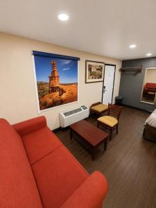 a living room with a red couch and a picture of a tower at Buffalo Inn Vintage MOTEL in Canyon +13 photos