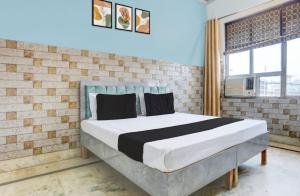 a bedroom with a bed in a brick wall at Park's Hotel Mbd in Morādābād